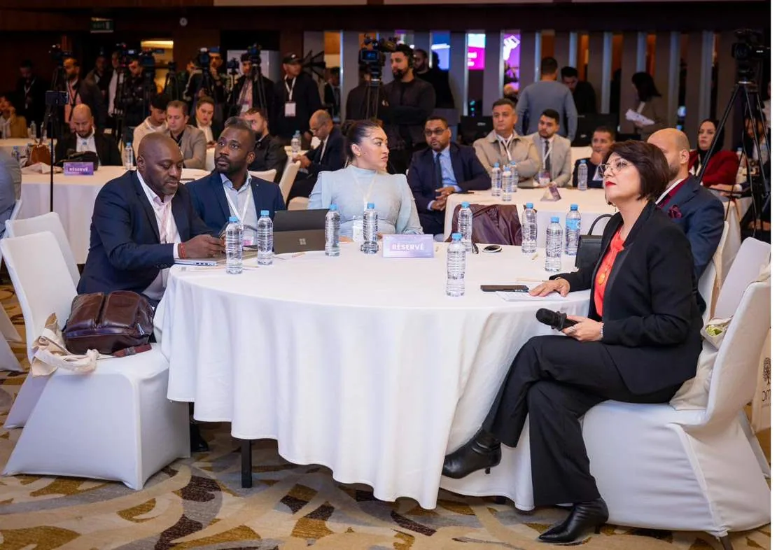 Delegates at a round table during a keynote