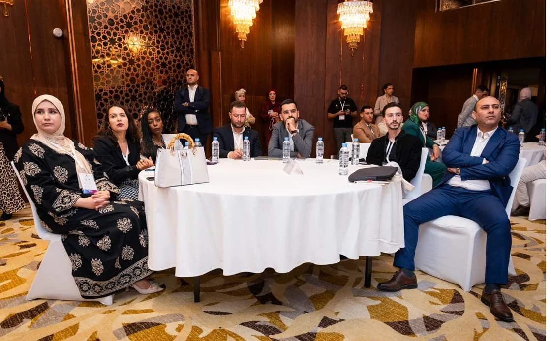 Delegates at a round table in the conference hall