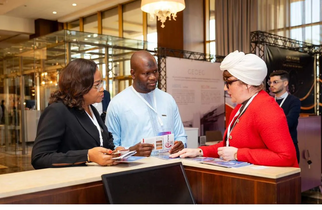 Delegates in conversation at an exhibitor desk