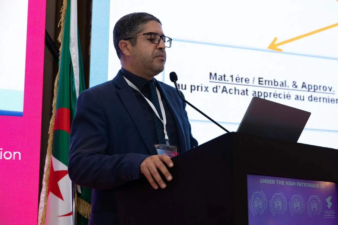 A speaker presenting market data from the podium