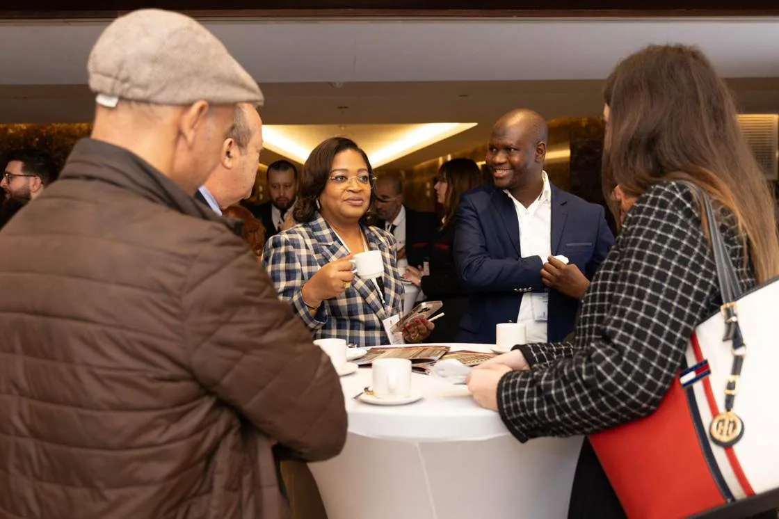 Delegates in conversation during a coffee break