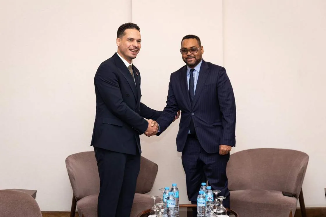 Two executives shaking hands in the VIP lounge